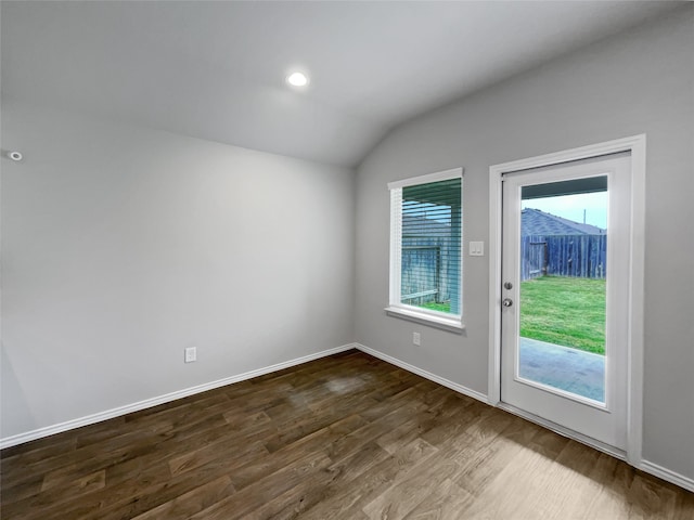 empty room featuring lofted ceiling and dark wood-type flooring