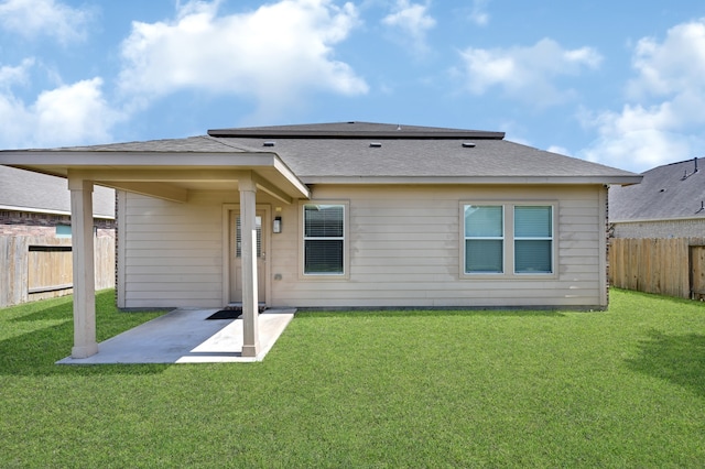 rear view of house with a patio area and a lawn