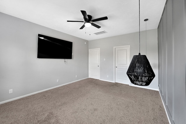 unfurnished bedroom with ceiling fan and carpet floors