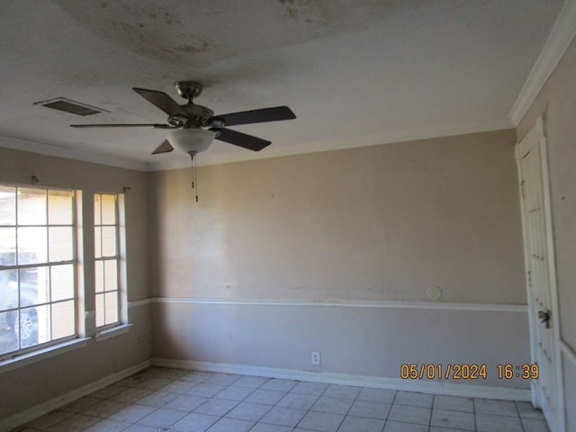 tiled empty room featuring crown molding and ceiling fan