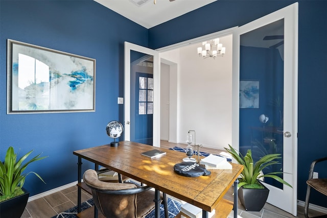 office with baseboards, a notable chandelier, visible vents, and wood tiled floor