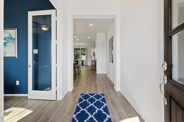 entryway featuring recessed lighting, baseboards, and wood finish floors