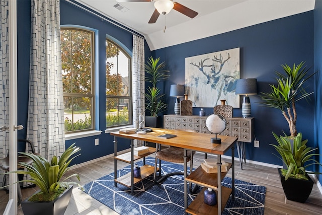 home office featuring wood finish floors, visible vents, and a healthy amount of sunlight