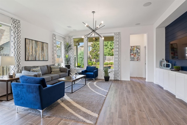 living area featuring a chandelier and wood tiled floor