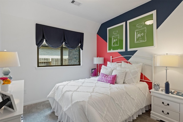 carpeted bedroom with visible vents and vaulted ceiling