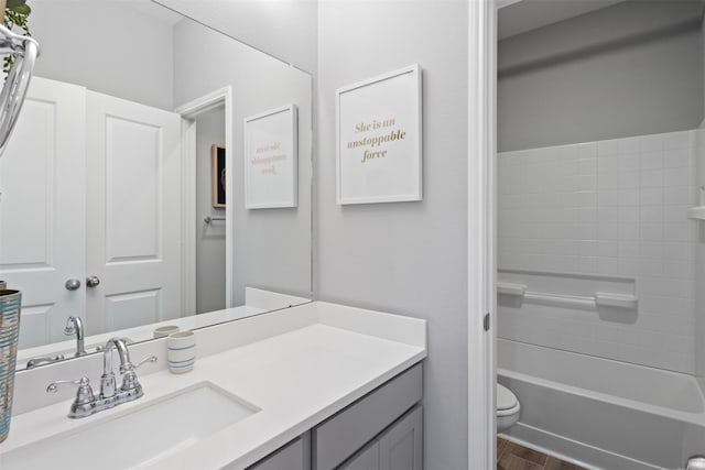 bathroom with toilet, wood finished floors, and vanity