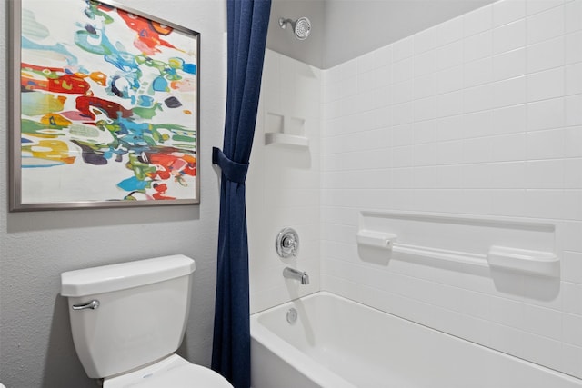 bathroom featuring a textured wall, shower / tub combo, and toilet