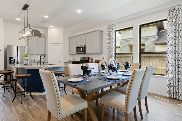 dining room with wood tiled floor, visible vents, baseboards, and recessed lighting