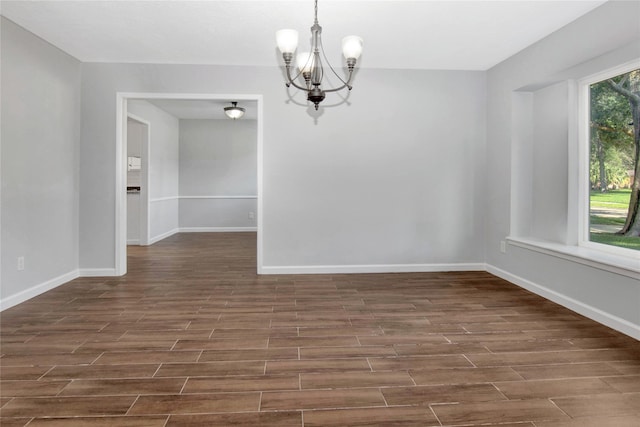427 Pebblebrook Dr, El Lago, TX 77586 - unfurnished room featuring a notable chandelier and dark wood-type flooring