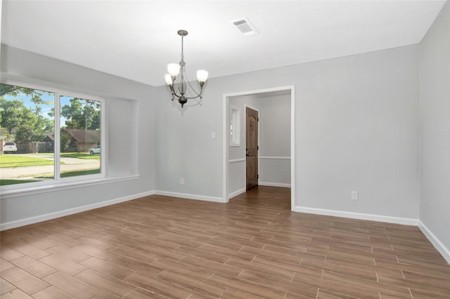 427 Pebblebrook Dr, El Lago, TX 77586 - unfurnished room with an inviting chandelier and hardwood / wood-style flooring