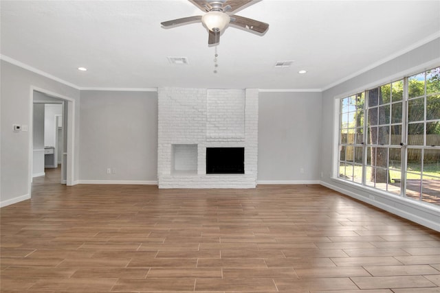 427 Pebblebrook Dr, El Lago, TX 77586 - unfurnished living room featuring brick wall, a brick fireplace, ornamental molding, and ceiling fan