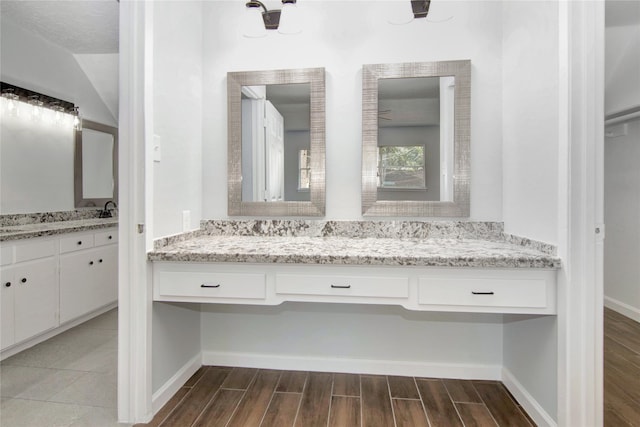 427 Pebblebrook Dr, El Lago, TX 77586 - bathroom with a textured ceiling, vanity with extensive cabinet space, and hardwood / wood-style floors