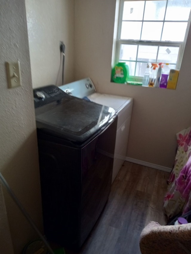 laundry room with hardwood / wood-style floors and washer and clothes dryer