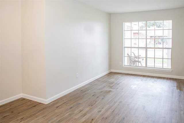 spare room with wood-type flooring