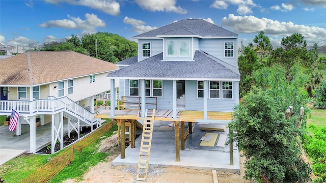 exterior space featuring a wooden deck and a patio