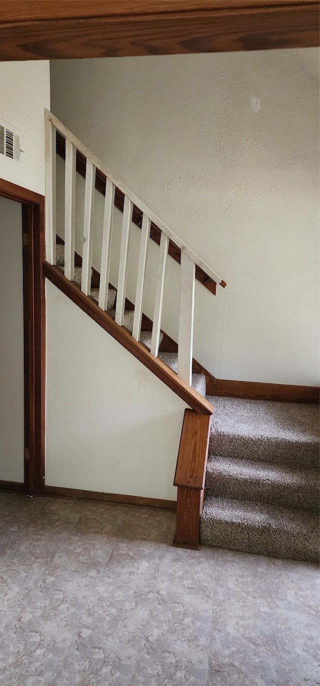 stairway featuring concrete floors