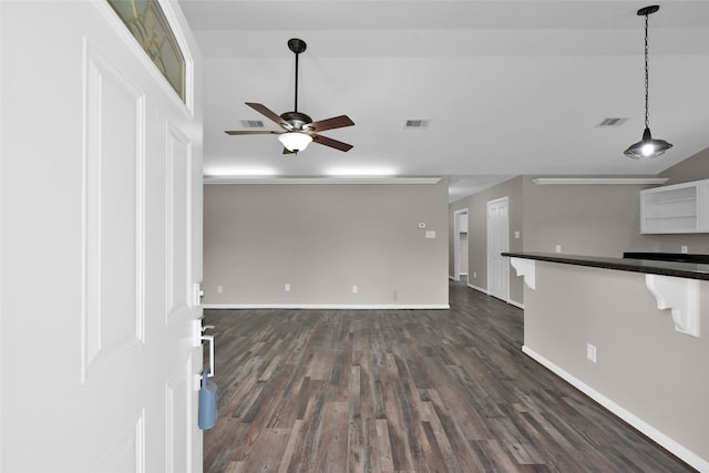 unfurnished living room featuring dark hardwood / wood-style floors and ceiling fan