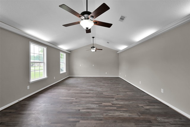 empty room featuring crown molding, dark wood-type flooring, ceiling fan, and vaulted ceiling