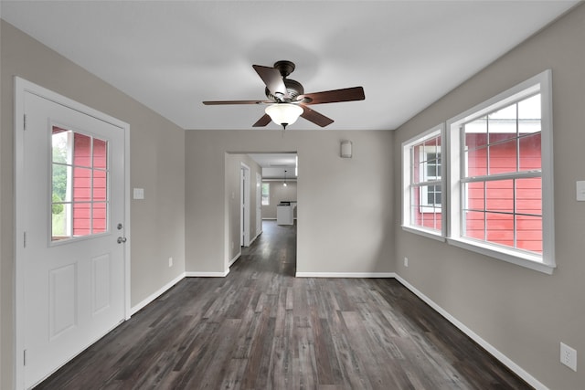 interior space with dark wood-type flooring and ceiling fan