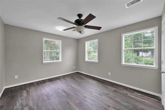 unfurnished room with ceiling fan and dark wood-type flooring