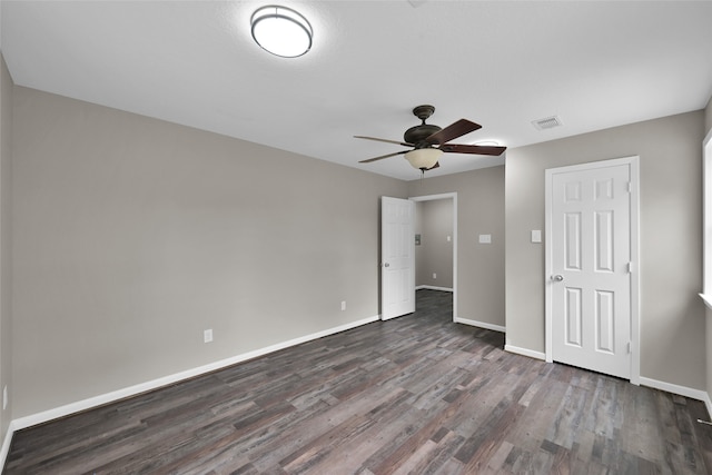 unfurnished bedroom featuring dark wood-type flooring and ceiling fan