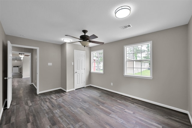 unfurnished bedroom with dark hardwood / wood-style flooring, a closet, and ceiling fan