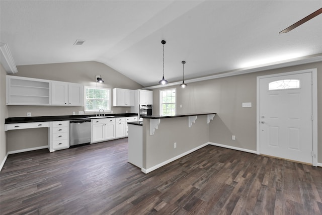 kitchen with a kitchen breakfast bar, stainless steel appliances, dark wood-type flooring, hanging light fixtures, and lofted ceiling