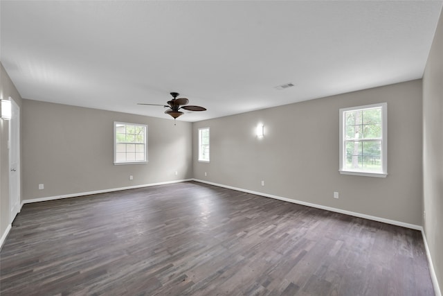 spare room with ceiling fan and dark hardwood / wood-style flooring