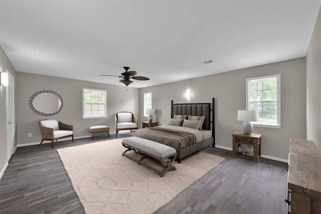 bedroom with dark wood-type flooring, ceiling fan, and multiple windows