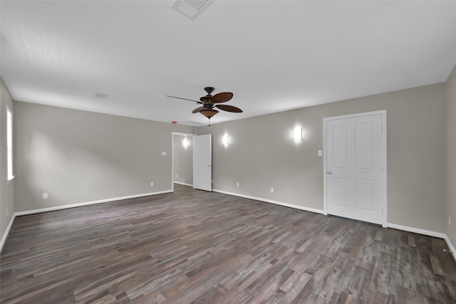 spare room featuring dark hardwood / wood-style flooring and ceiling fan