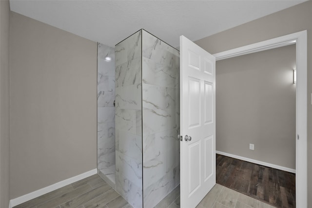 bathroom with hardwood / wood-style flooring