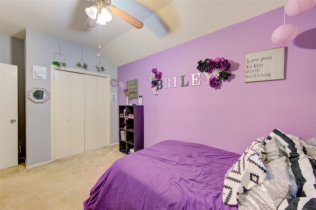 carpeted bedroom featuring a closet, ceiling fan, and lofted ceiling