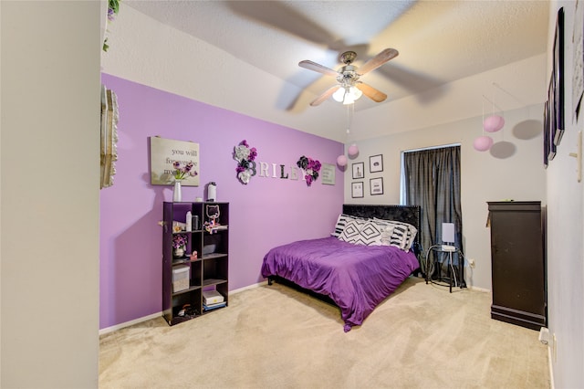 bedroom with a textured ceiling, ceiling fan, and carpet flooring