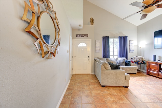 foyer featuring high vaulted ceiling, ceiling fan, and tile floors