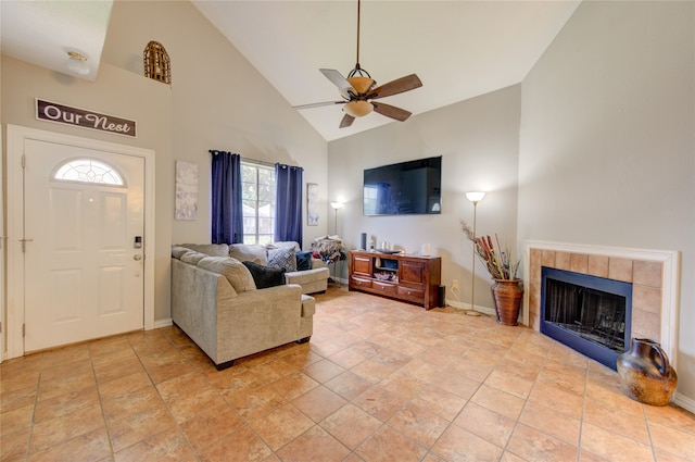 tiled living room featuring high vaulted ceiling, ceiling fan, and a fireplace