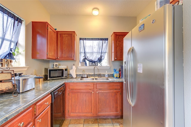 kitchen with sink, appliances with stainless steel finishes, and light tile floors