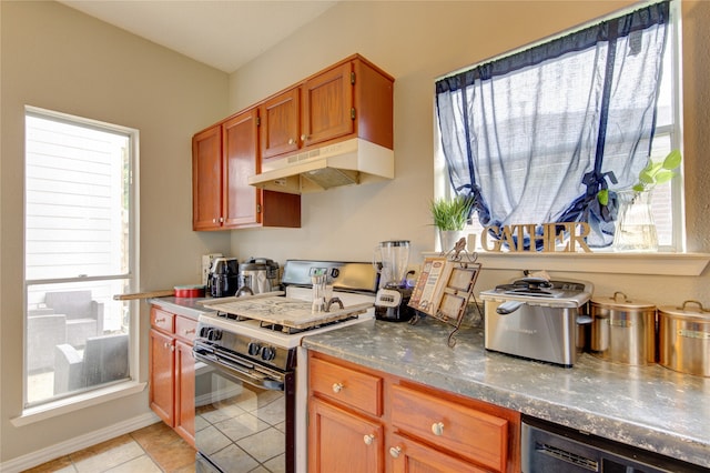 kitchen featuring light tile floors and white electric range