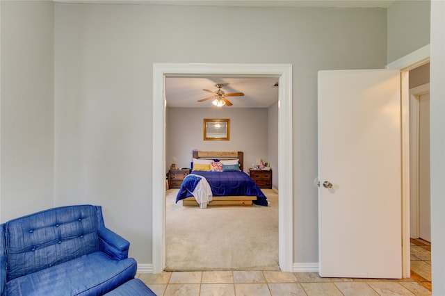 bedroom featuring ceiling fan and light tile floors