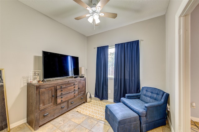 sitting room featuring ceiling fan and light tile floors