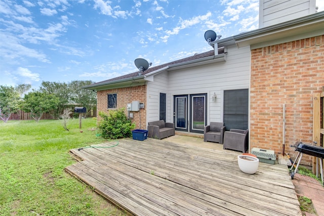 wooden terrace featuring a yard