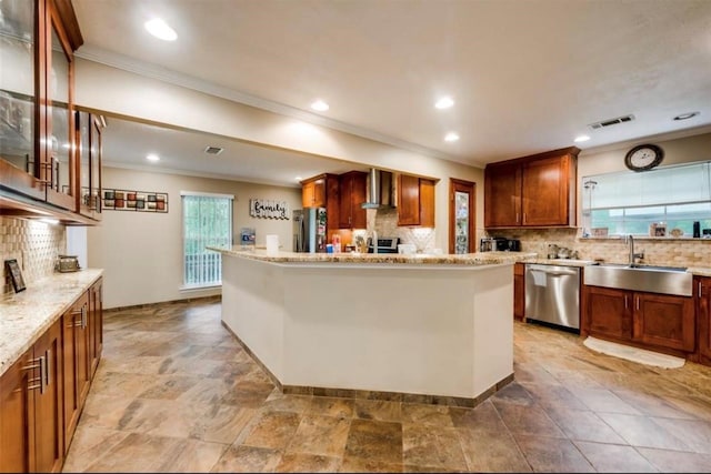 kitchen featuring appliances with stainless steel finishes, wall chimney exhaust hood, sink, tasteful backsplash, and tile floors