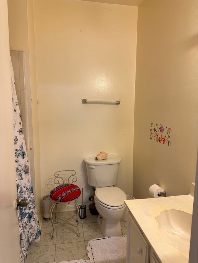 bathroom featuring vanity, toilet, and tile flooring