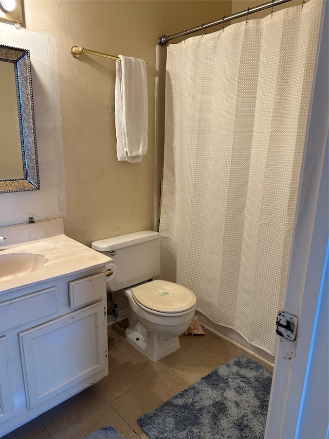 bathroom featuring vanity, tile floors, and toilet