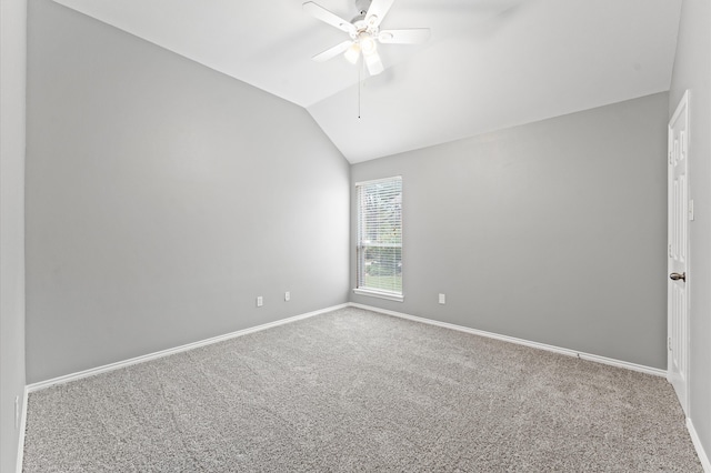 spare room featuring vaulted ceiling, ceiling fan, and carpet