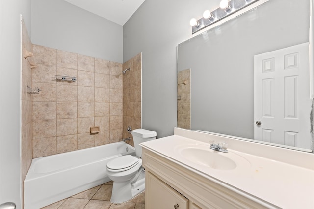 full bathroom with tiled shower / bath combo, toilet, tile floors, and vanity