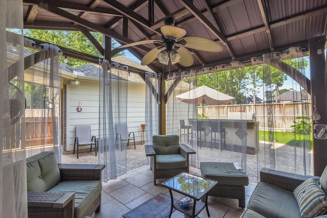 view of patio / terrace featuring ceiling fan, fence, outdoor dry bar, and an outdoor hangout area