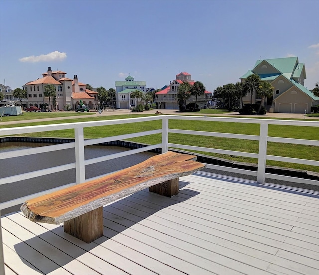 wooden deck with a lawn and a residential view