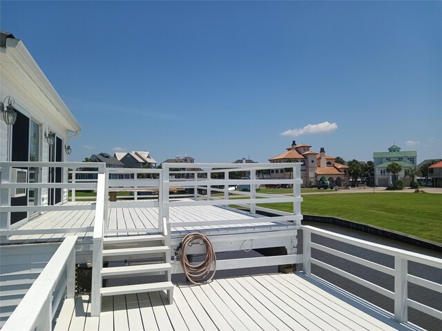 wooden terrace with a yard and a residential view