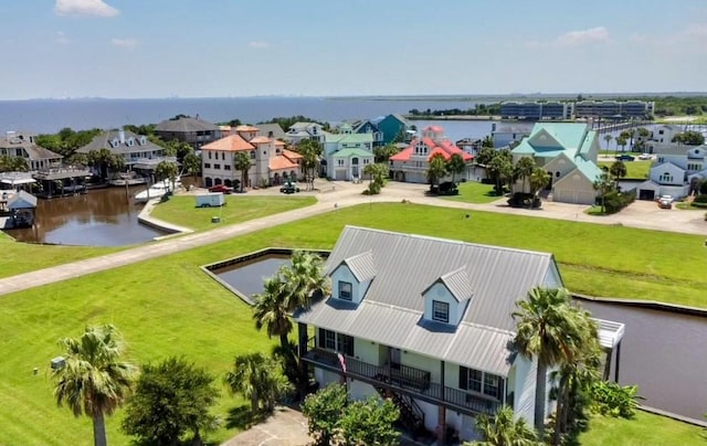 birds eye view of property with a water view and a residential view