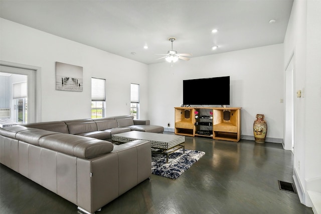 living room featuring ceiling fan and dark hardwood / wood-style floors